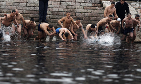 Russian Orthodox Christians take religious plunges into icy waters