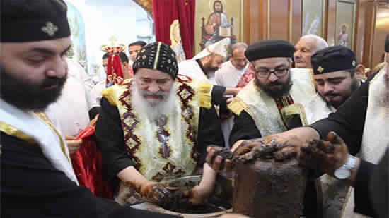 Bishop of Qena perfumes  the remains of St. Rebecca and the three peasants
