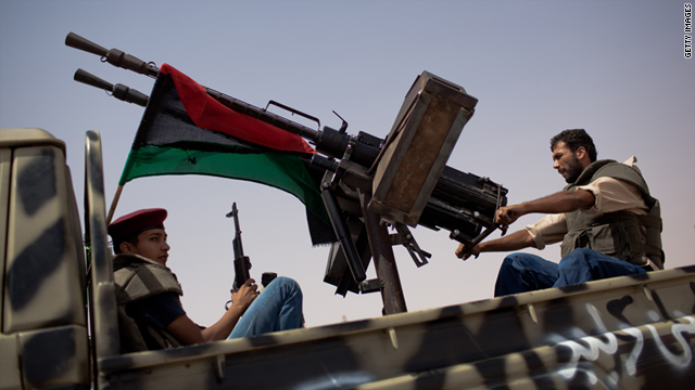 Libyan fighters positioned outside of Gadhafi strongholds
